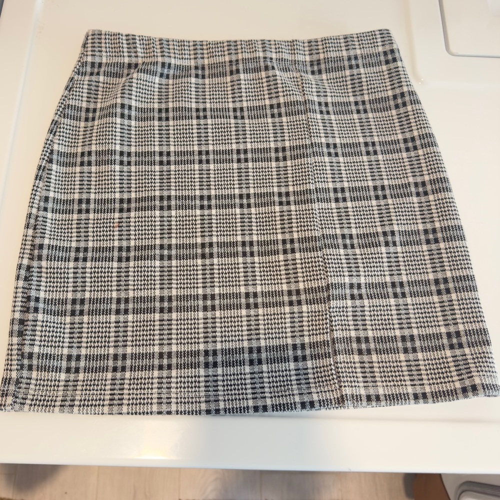 Black and white plaid mini skirt with small front slit
